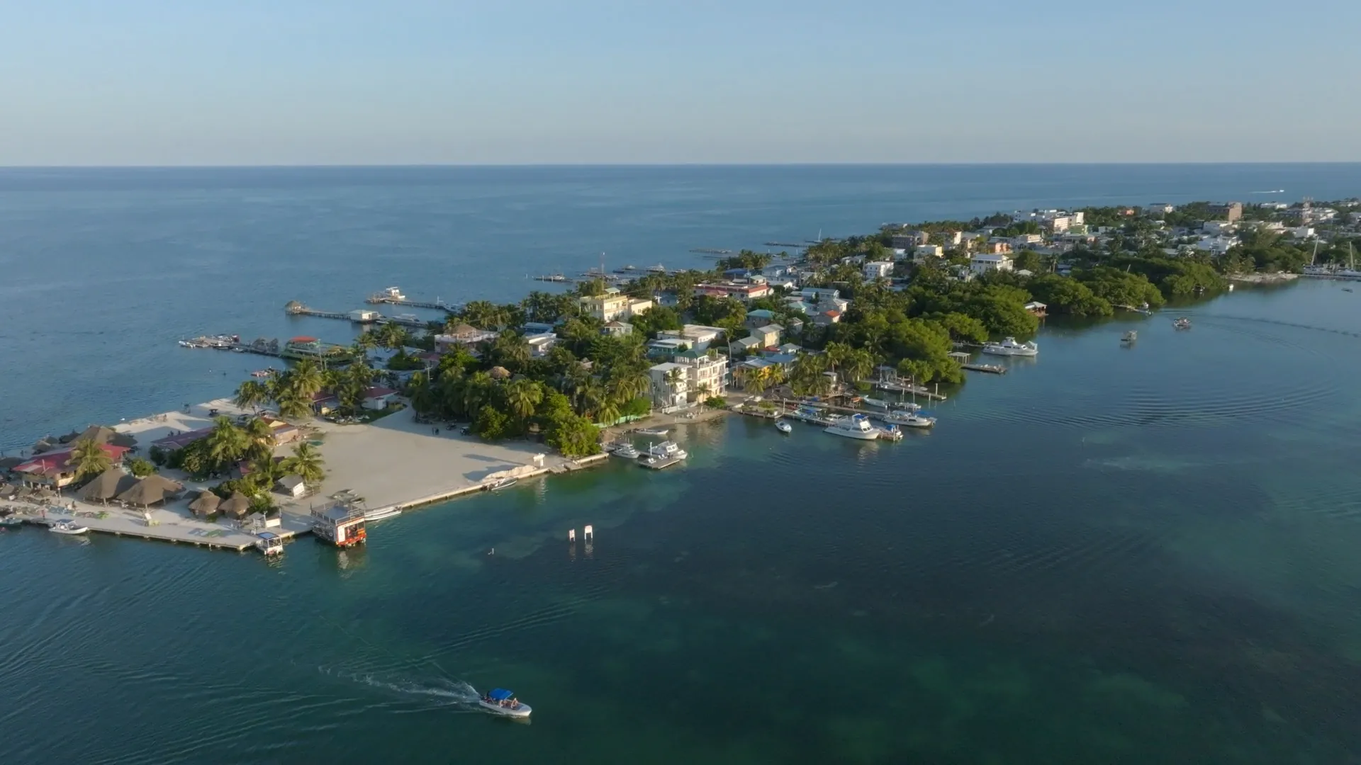 Aerial view of Caye Caulker, Belize — island homes, docks and turquoise water